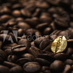 Individuality concept, close up of a single bright, gold coffee bean over many dark ones with copy space
