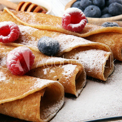 Delicious Tasty Homemade crepes or pancakes with raspberries and blueberries