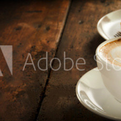 Cup of hot cappuccino coffee with cake