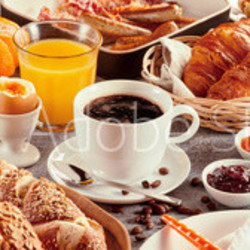 Breakfast with coffee surrounded by various food