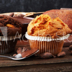 Chocolate muffin and nut muffin, homemade bakery on dark background