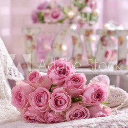 romantic pink rose bouquet lying on the bed