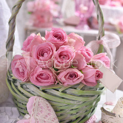 romantic bunch of pink roses in wicker basket