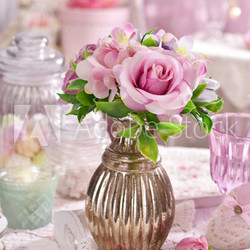 bunch of pink flowers in vase on the table in shabby chic style