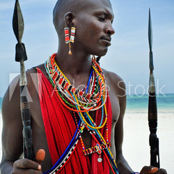 Maasai sitting by the ocean on the beach