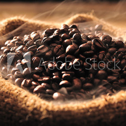 Coffee beans with smoke in burlap sack