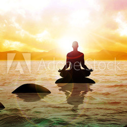 A man figure meditating on calm water during sunrise
