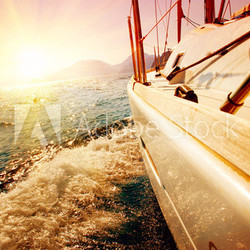Yacht Sailing against sunset. Sailboat. Yachting. Sailing