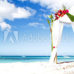 wedding arch decarated with flowers on beach