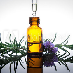 Essential oil with rosemary flowers