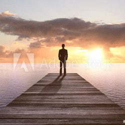man standing on pier