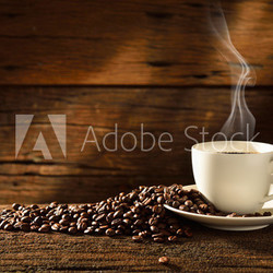 Coffee cup and coffee beans on old wooden background