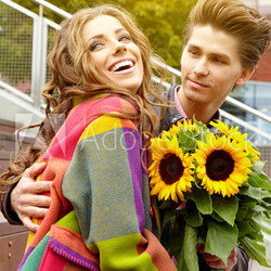 happy young couple spending time outdoor in the autumn park