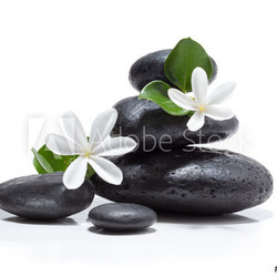 tiare flowers, candle and black stone spa