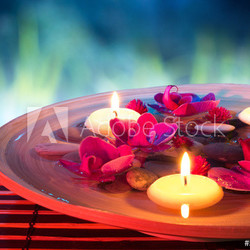 dish spa with floating candles, orchid, in garden