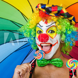 Clown with umbrella and lollypop