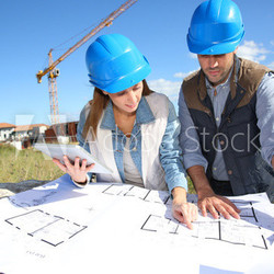 Construction people looking at blueprint