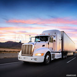 Truck and highway at sunset - transportation background