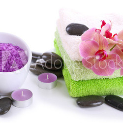 Still life with beautiful blooming orchid flower, towels and
