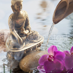 religious incense next to water Buddha