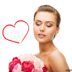 woman wearing earrings and holding flowers
