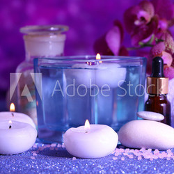 Beautiful spa setting with orchid on purple background