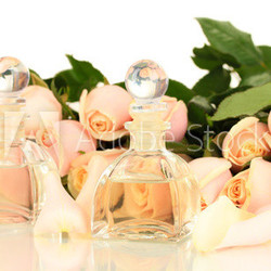 Beautiful bouquet of roses and perfume, isolated on white