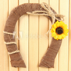 Decorative horseshoe of straw with sunflower,