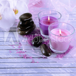 Beautiful colorful candles and  orchid flowers,