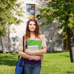 smiling student with bag, folders and tablet pc