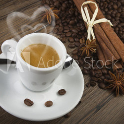 cup of coffee with heart of steam, cinnamon sticks and anise