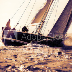 sail boat sailing on sunset