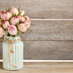 Bouquet of pink roses in turquoise ceramic vase