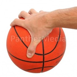 Hand holding a basketball ball isolated