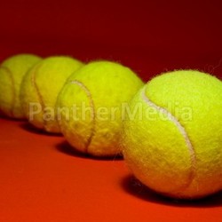 tennis balls on red
