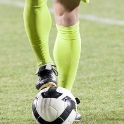 Soccer player with his foot on  the ball