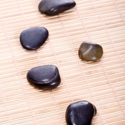 zen stones on bamboo mat